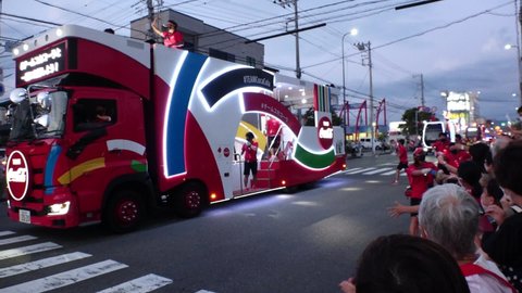 NUMAZU-SHI, SHIZUOKA, JAPAN - 24 JUNE 2021 : Tokyo 2020 Olympic Torch Relay at Numazu-shi area. View of torch parade. Slow motion shot.