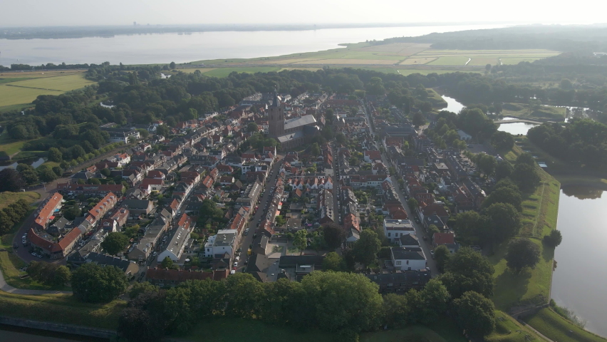 Aerial of the beautiful old town of Naarden, the Netherlands. Drone flying towards a classic large church located in the city center