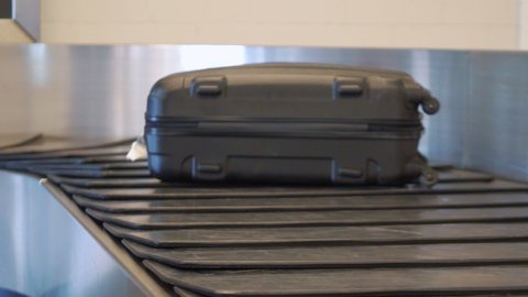 Suitcases and bags on the luggage carousel in 4k slow motion 60fps