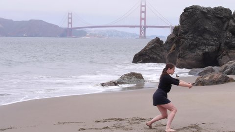 Woman Draws a Line in the Sand, Metaphorically and Literally, Dancing on the Beach