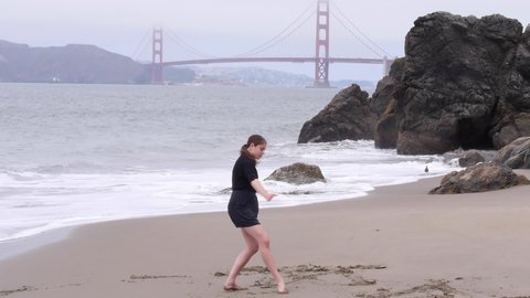 Wide Shot, Woman Dances Interpretively Using Dramatic Expression, Foggy Beach Day