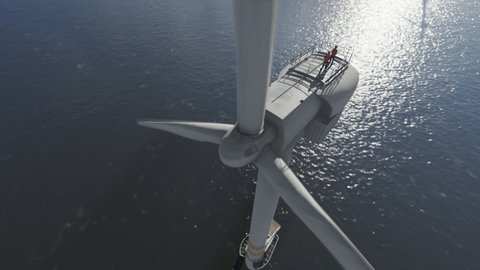 Workers on top of offshore wind turbines against morning sun, tilt 4K
