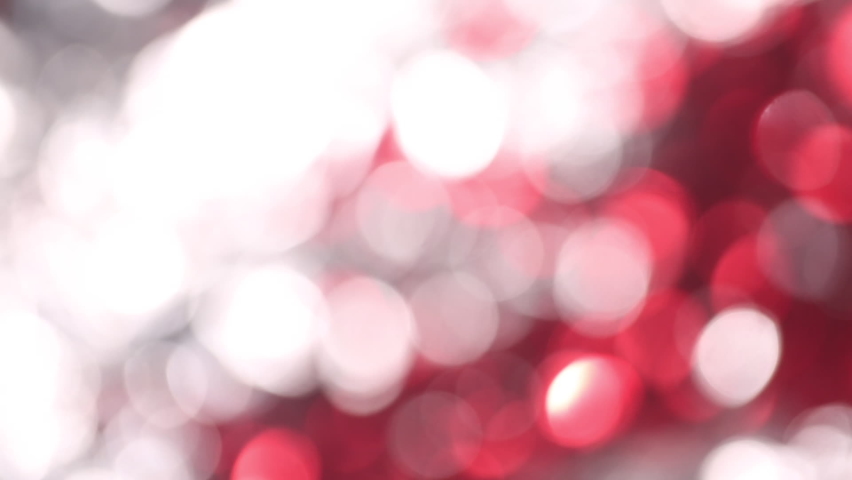 Blurred bokeh in motion with flying red lights and silver highlights Royalty-Free Stock Footage #1076363999