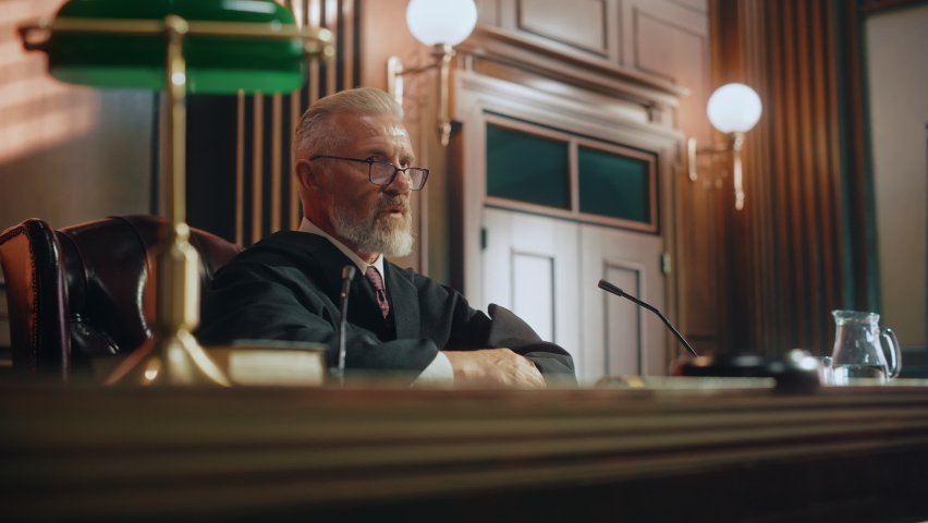 Court of Justice Trial: Portrait of Impartial Judge Reading Decision, Pronouncing Sentence, striking Gavel. Unbiased Judgment after Deliberation Find the Defendant Guilty, Not Guilty Verdict Royalty-Free Stock Footage #1076370797