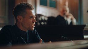 Court of Law and Justice Trial Stand: Portrait of Aggressive Angry Criminal Denying Charges, Lying to Escape Justice to Break the Law Again. Male Witness Giving Expressive, Emotional Testimony - Powered by Shutterstock - Get 15% off with code: PIKWIZARD15