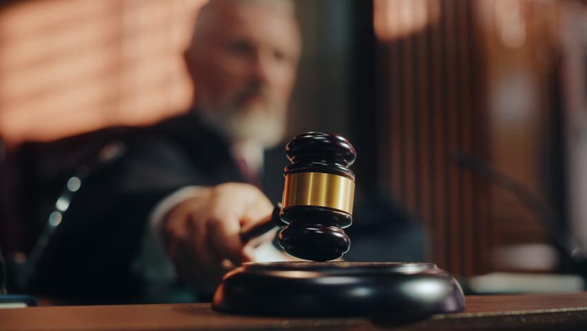 Court of Law and Justice Trial Session: Imparcial Honorable Judge Pronouncing Sentence, striking Gavel. Focus on Mallet, Hammer. Cinematic Shot of Dramatic Not Guilty Verdict. Blurred Slow Motion Royalty-Free Stock Footage #1076370848