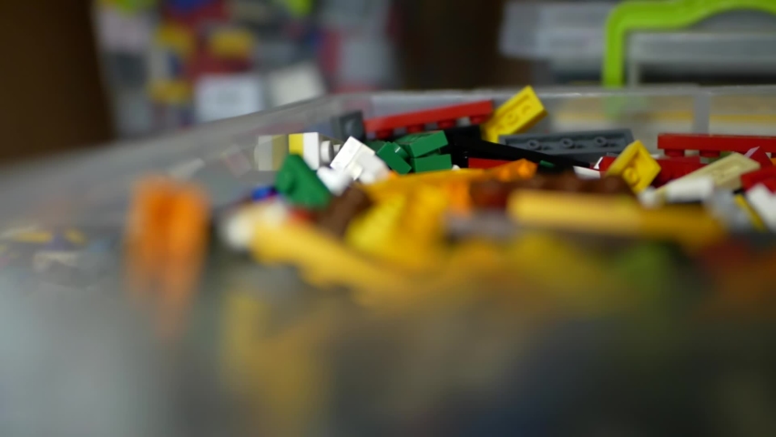 Close-up of a student's hand in an engineering class making a robot. Robotics education. Kids play with toys from building blocks. Colorful constructor in a box. An entertaining educational game. Royalty-Free Stock Footage #1076373719