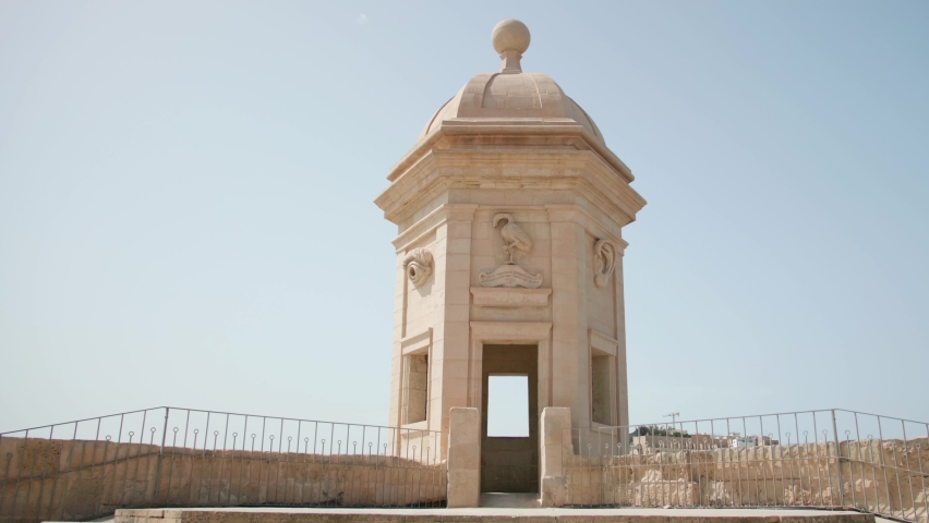 A couple of tourists arriving at the Guard Tower of the Gardjola Gardens fortifications in Senglea (Isla, Three Cities), Island of Malta.