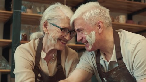 Pottery Art, Senior Couple, Mutual Support, Elderly Age. Loving couple Senor man and senor woman are enjoying themselves during the pottery art.