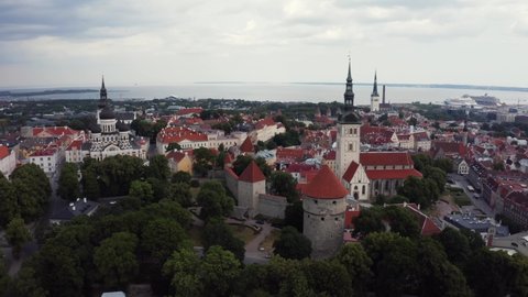 Aerial view of medieval Tallinn city in Estonia, Baltics. Beautiful view of the old town of Tallinn with orange roofs and narrow streets below.