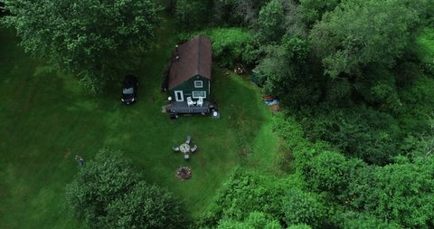 A high zoom reveal of a small secluded cabin off the grid in the Catskill Mountains New York.