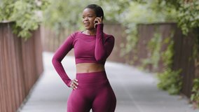 Purposeful athletic black millennial girl gets long-awaited important phone call during her morning run, daily workout. Young mixed race woman hears signal, interrupts jogging outdoors to answer - Powered by Shutterstock - Get 15% off with code: PIKWIZARD15