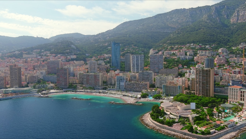 Monte Carlo, Monaco. Aerial view of famous city towering over Mediterranean Sea, modern high-rise buildings, Les Plages beaches  - landscape panorama of Europe from above