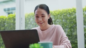 Happy teenage girl or college mba student sit watch and play social media on desk table work at home via digital tablet. Asia people female relax enjoy job reskill upskill seminar class on notebook. - Powered by Shutterstock - Get 15% off with code: PIKWIZARD15