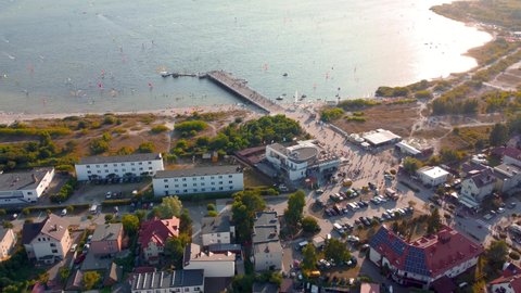 Jastarnia, Poland - July 20, 2021: Aerial sunny view on coast with wooden pier. Sunset on Hel peninsula at Puck Bay on Baltic Sea.