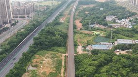 Aerial video of white high-speed rail running on China's suburban railway