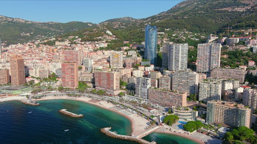 Monte Carlo, Monaco. Aerial view of famous city towering over Mediterranean Sea, modern high-rise buildings, Les Plages beaches  - landscape panorama of Europe from above