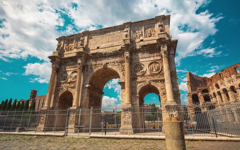 Motion 4K timelapse of the Arch of Constantine and Coliseum with turists during a sunny day, Rome, Italy