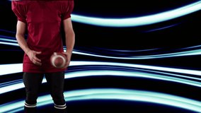 American football player holding ball over light trails. global sports, fitness, science and data processing concept digitally generated video.