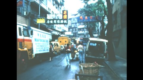 HONG KONG, CHINA - CIRCA 1987: old road of Hong Kong downtown with vintage cars. Historic archival of city downtown with people and workers in 1980s.