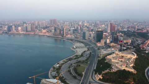 Fast motion traveling front, Luanda city, golden hour flying over Luanda bay, Africa 