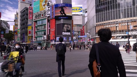 Tokyo , Japan - 01 04 2021: POV walking across famous Shibuya scramble during Corona Pandemic