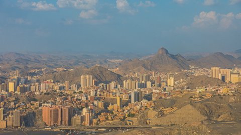 Time lapse: Wide angle Mecca landscape view during day from afar overlooking Makkah city skyline in Saudi Arabia with the Jabal Al Nour in the background. Pan up motion timelapse. 