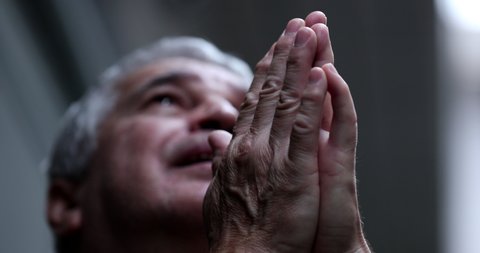 Spiritual older man feeling the presence of God praying and feeling grateful