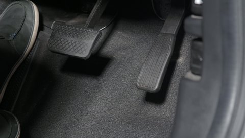 Accelerator and break pedal in a car. Close up the foot pressing foot pedal of a car to drive. Driver driving the car by pushing accelerator pedals of the cars. inside auto vehicle. Car foot pedal. 