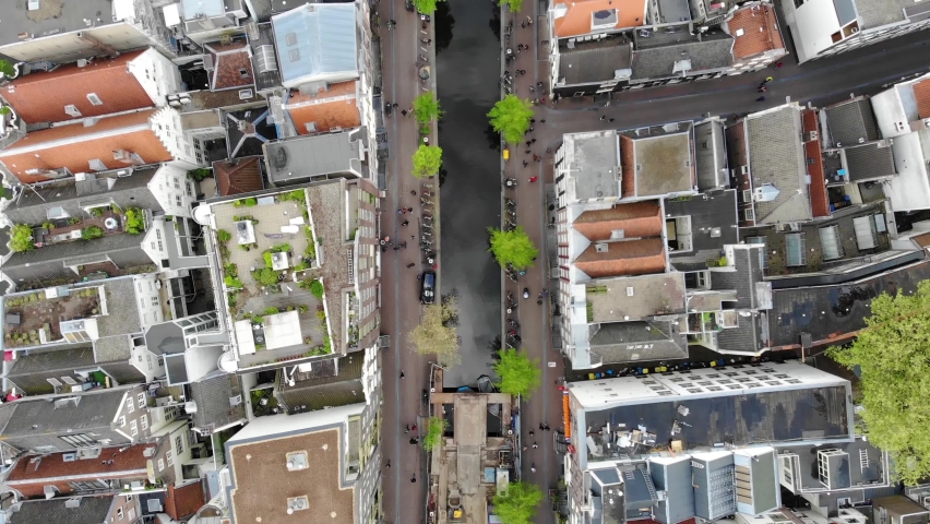 Aerial shot of a beautiful view from above of architectural buildings and Amsterdam canal. Netherlands in 4K