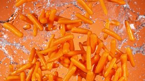 Super Slow Motion Shot of Flying Fresh Baby Carrots and Water Side Splash at 1000 fps. - Powered by Shutterstock - Get 15% off with code: PIKWIZARD15