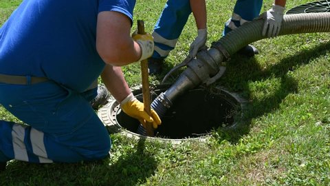 Ljubljana, Slovenia, July 15, 2021.Emptying household septic tank. Cleaning sludge from septic system.