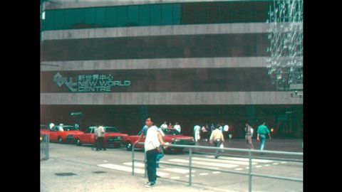 HONG KONG, Tsim Sha Tsui, Kowloon, CHINA - CIRCA 1987: Taxi and cab drivers at New World Centre of Hong Kong by Victoria Harbour. Historic retail-hotel-residential-office complex in 1980s.