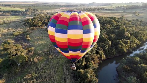 Isolated hot air balloon. Panorama landscape of isolated hot air balloon at countryside scene. Hot air balloon aerial view. Balloon in the air. Rural forest landscape. Sport adventure ballooning