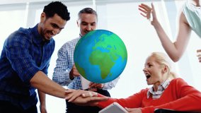 Animation of globe rotating over smiling diverse colleagues stacking hands at casual office meeting. global communication concept digitally generated video. - Powered by Shutterstock - Get 15% off with code: PIKWIZARD15