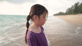 Asian happy girl walking on the white sand beach at Phuket while Phuket sandbox travel project