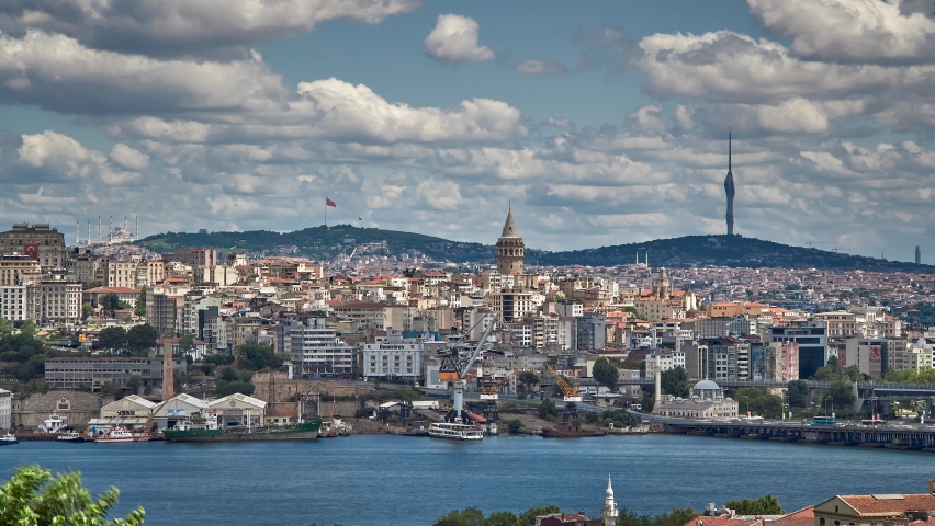 Panorama time lapse on a beautiful cloudy and windy summer day in Istanbul, Turkey. Old Galata Tower, Halic, Sishane region and new Camlica Hill Mosque, Tv Radio Tower are at the background.
