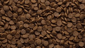 Pet dry food top view, rotation. Pile of cat or dog pellets. 4K UHD video