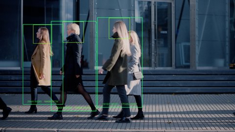 Crowd of Business People Tracked with Technology Walking on Busy Urban City Streets. CCTV AI Facial Recognition Big Data Analysis Interface Scanning, Showing Animated Information.