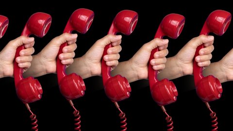 Loopable footage of man's hands holding red vintage telephone handsets moving against a black background 