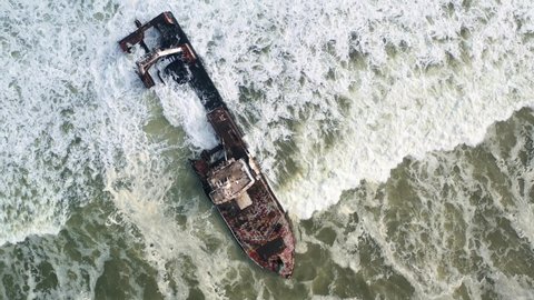 Flight over the shipwreck in the Atlantic ocean on Skeleton Coast near Swakopmund in Namibia, Africa. Top view. UHD 4k drone video footage