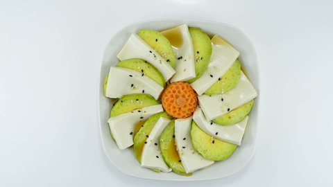 Tofu Avocado Salad with Soy Sauce Japanese Style ontop Sesame decorate carved carrot flower shape topview
