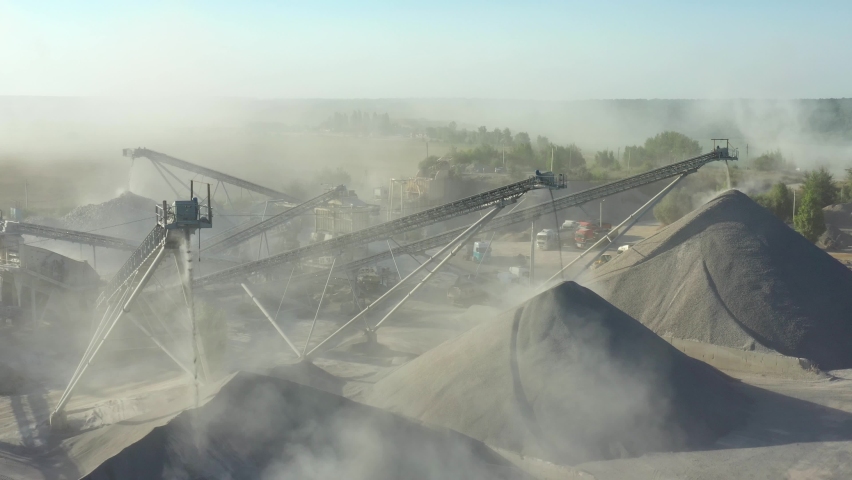 Conveyor belts and machinery at a gravel pit. Quarry for the extraction of granite. Granite quarry. Extraction of granite. Open cast mine. Mining industry. Stone Quarrying - Aerial view Royalty-Free Stock Footage #1076532245