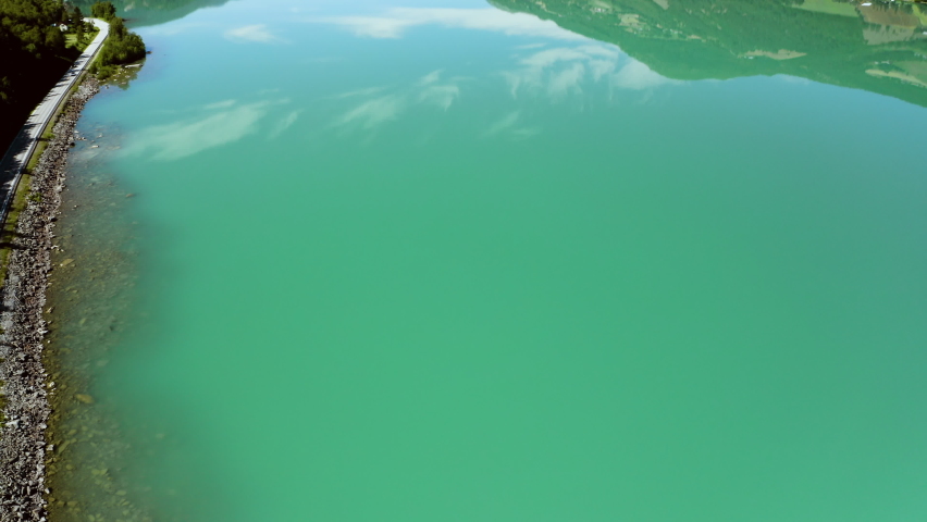 Scenic View Of Vagavatn Lake With Calm Water Offering Mountain Views In Summer In Norway. - tilt up