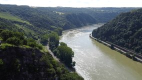 Video from a drone flying above the Rhine river in Germany, visible road on both sides of the river.