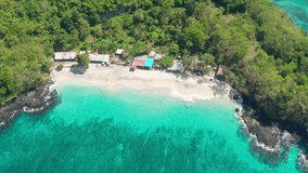 Beautiful aerial view on Secret Beach Bali, near Padang Bai Port famous port from which you can sail by ship to the island of Lombok and Nusa Penida. 4K Aerial UHD Video Clip.