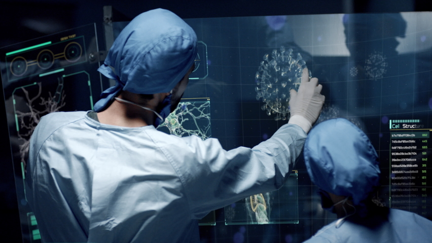 Professional Doctors Analyzing Viral Outbreak of Coronavirus Covid 19 Delta Variant. Virus Cell close up animation with infographics on futuristic transparent screen. Contagious Pandemic Disease. - Powered by Shutterstock - Get 15% off with code: PIKWIZARD15