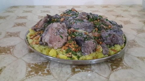 Mansaf. A chef serves Jordanian bedouin yogurt on a bed of rice and meat. Mansaf is the national dish of Jordan.
