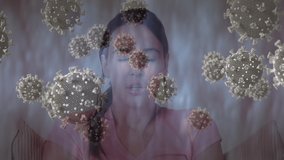 Animation of covid 19 cells floating over sick woman. global covid 19 pandemic concept digitally generated video.