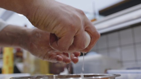 Squeezing water from mozzarella cheese. Close up on chef hands.